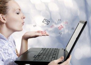 Concept - young attractive woman with laptop computer sending emails on forum, chat or blog. Blogger